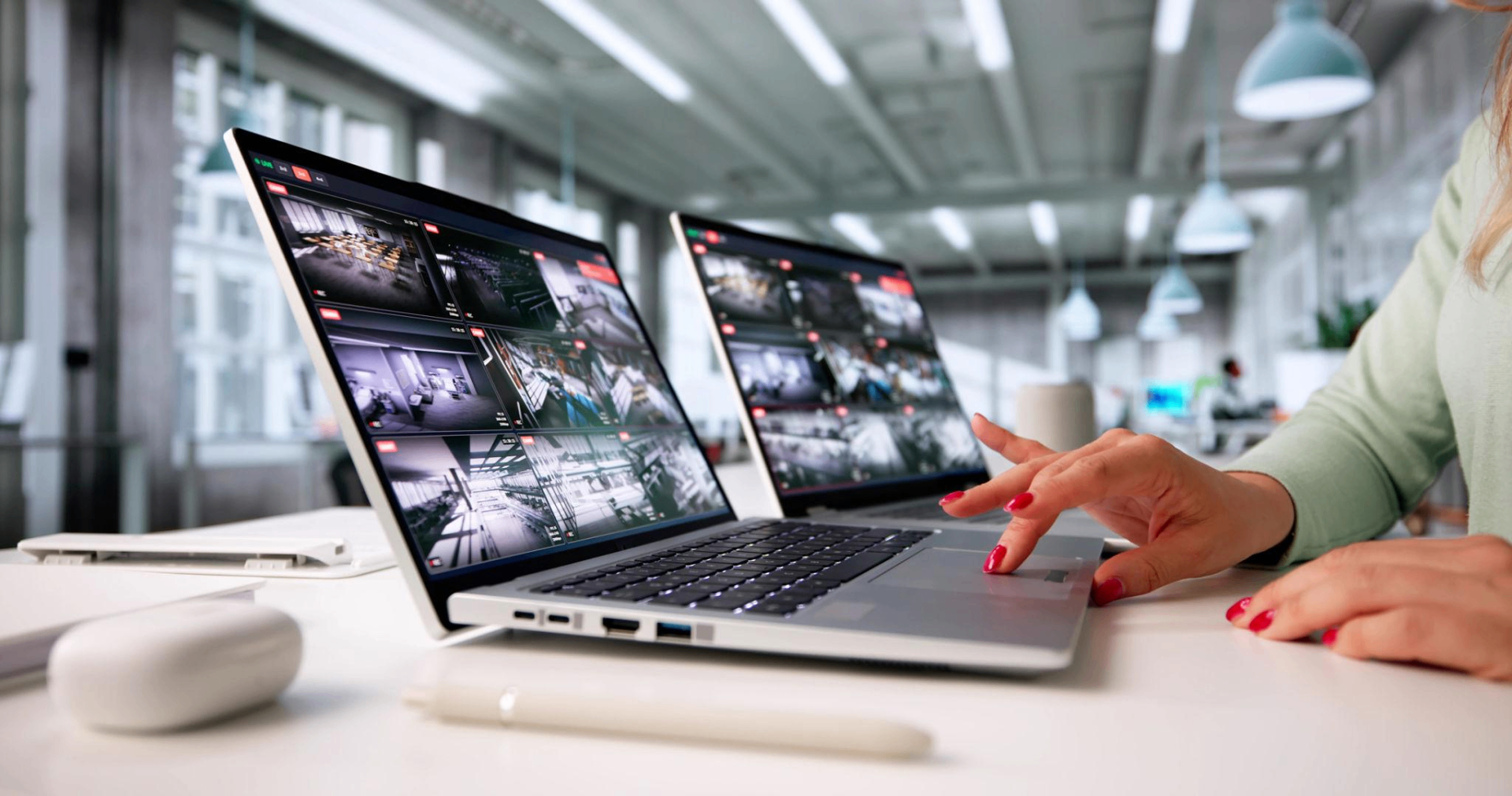 Multiple monitors displaying CCTV grids and digital evidence during a cyber crime investigation