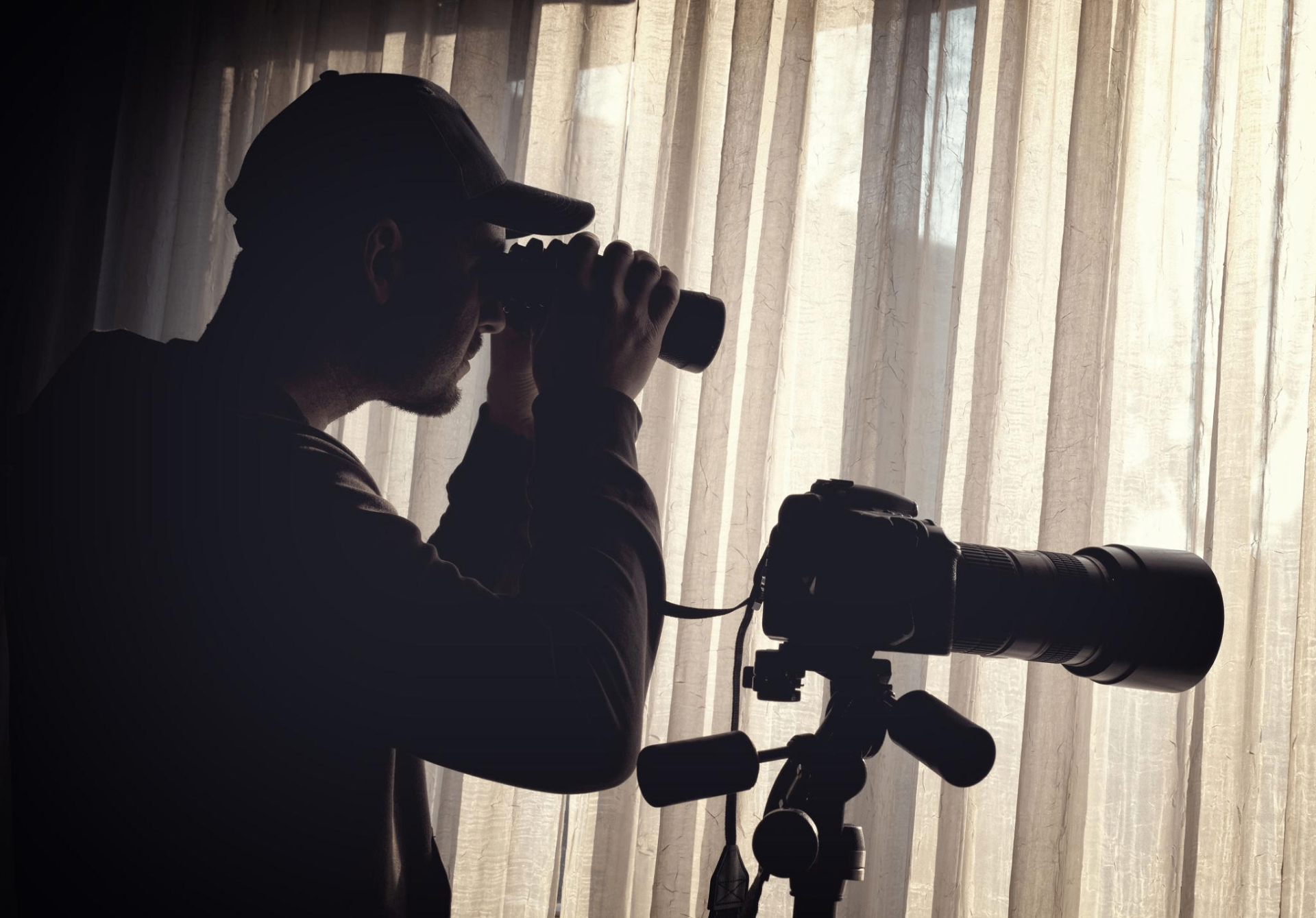 Silhouette of an investigator observing a subject from a distance during a matrimonial stakeout
